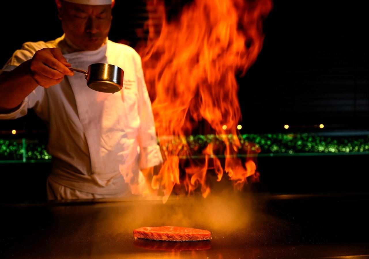 Hotel Monterey Okinawa Spa & Resort Onna Eksteriør billede A chef cooking with the technique of flambe